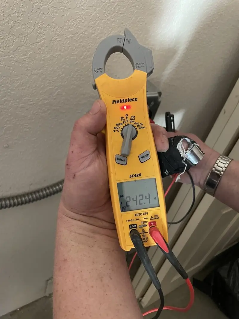 Voltage testing with clamp meter during Ceiling Fan Installation in St. Pete Beach